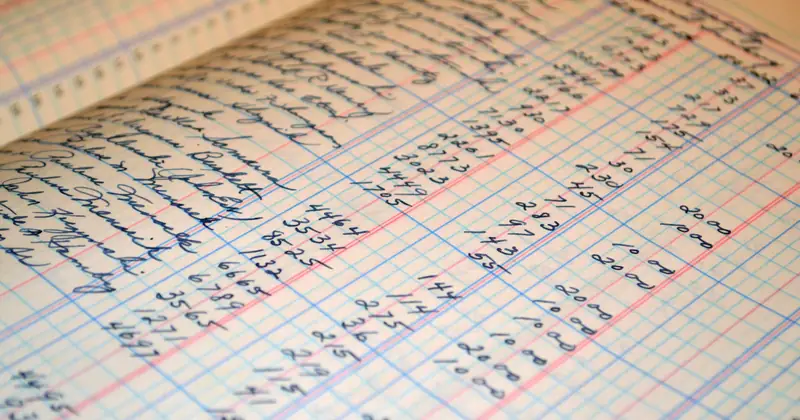 Close-up of a vintage handwritten ledger detailing financial records and accounts.