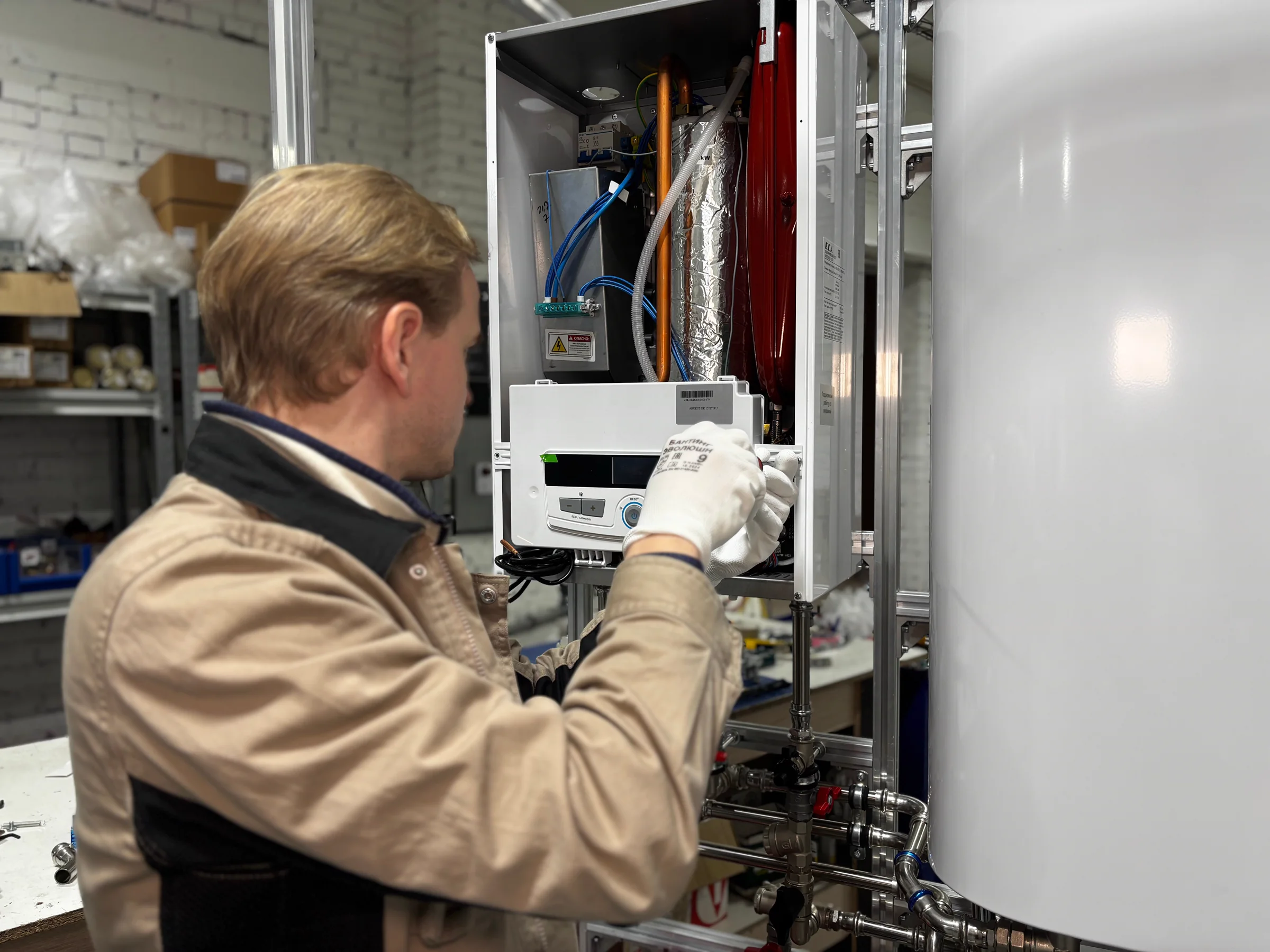 Technician repairing a heating system in a workshop