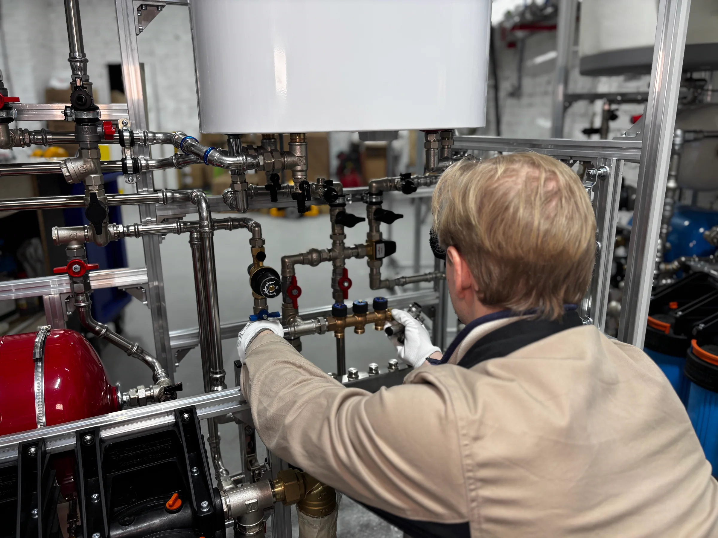 Engineer adjusting heating pipework