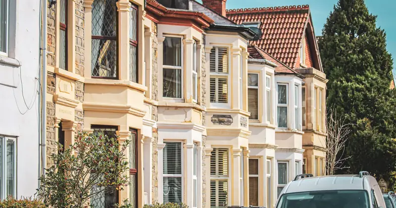 Elegant row houses with classic architecture on a sunny street in Bristol, UK.