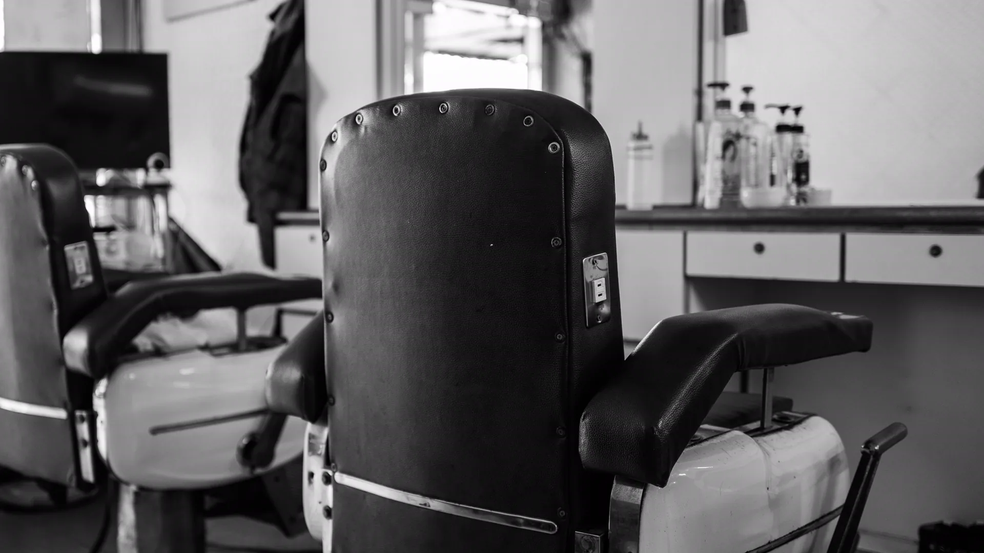 Leather chairs and mirrors inside Fade House