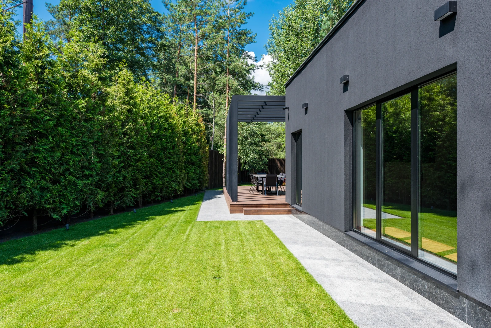 Modern garden room beside a clean paved edge.
