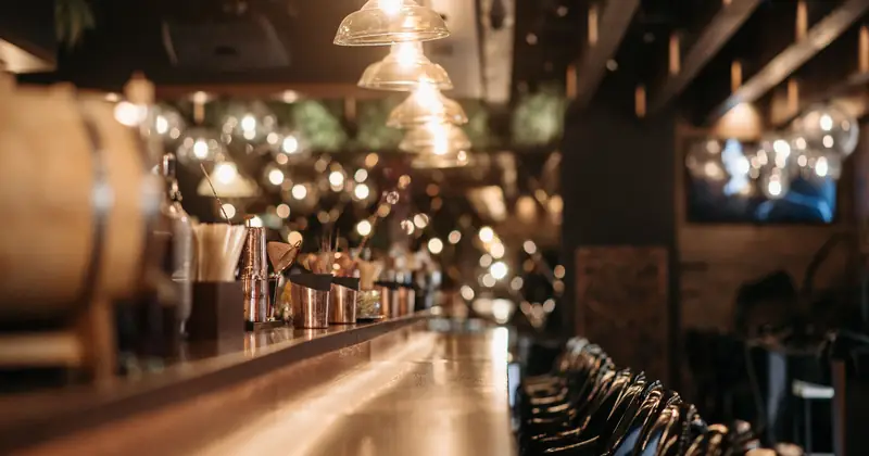 A warmly lit stock photograph of a café bar counter.