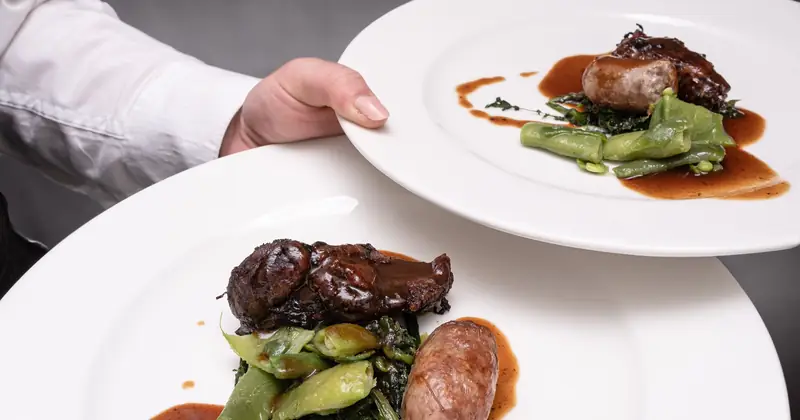 Grilled plate with greens and pan sauce, plated to order.