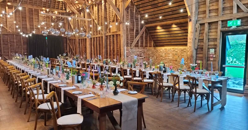 Ceremony chairs arranged beneath a timber roof