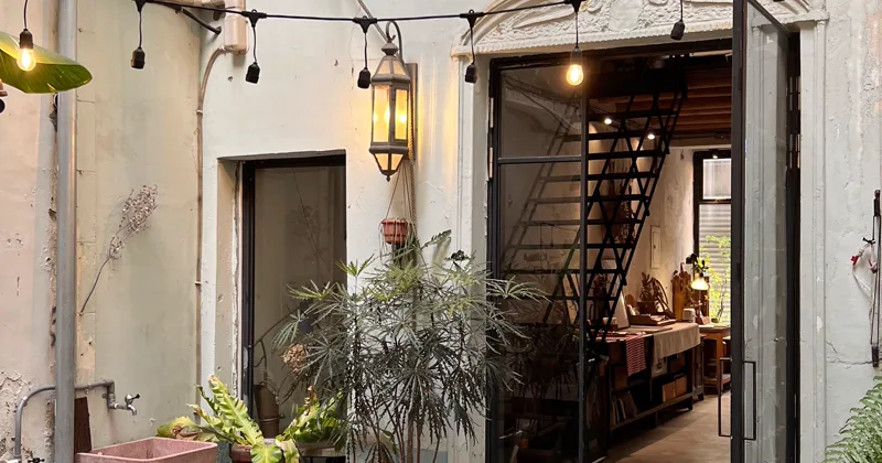 Outdoor tables beneath string lights at dusk