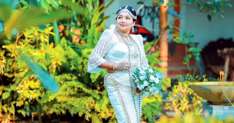 Bride walking through a lush garden, representing the Vowbarn grounds