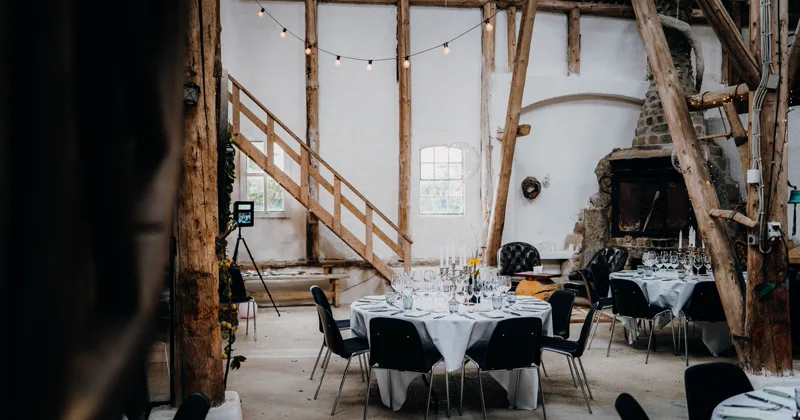Long reception table dressed with flowers and candles