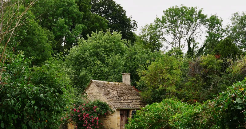Traditional stone cottage with a flowering garden, representing the Vowbarn stay